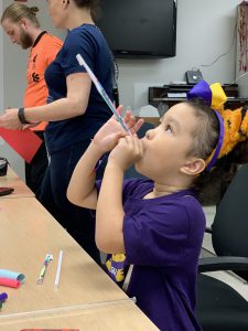Five-year-old Blythe Watson demonstrates a straw rocket launch.